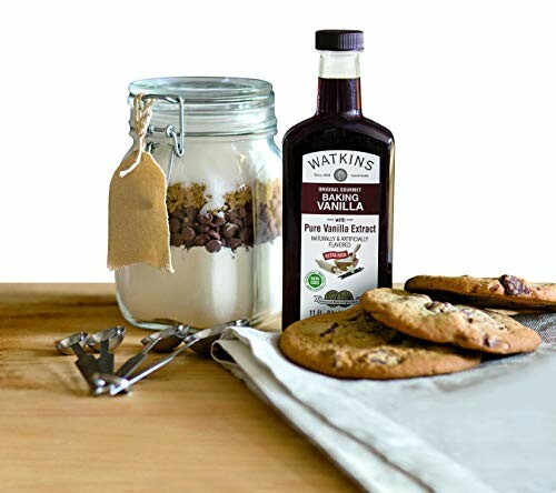 Baking ingredients with vanilla extract and cookies on a table