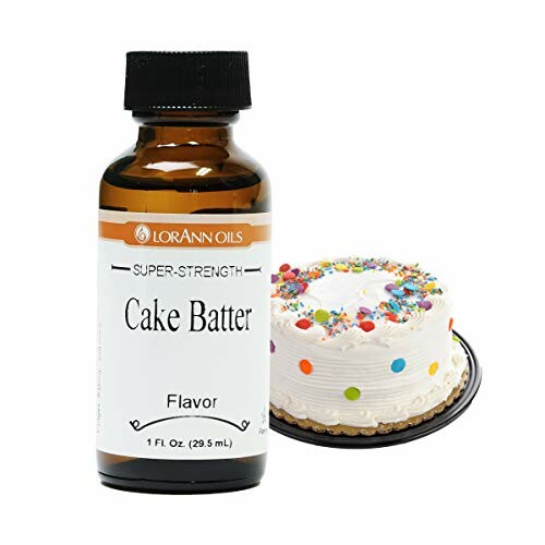 Cake batter flavoring bottle next to a decorated cake