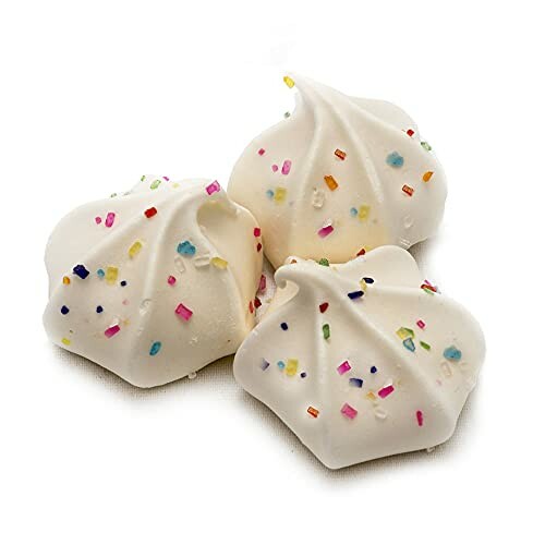 Three white meringue cookies with colorful sprinkles.