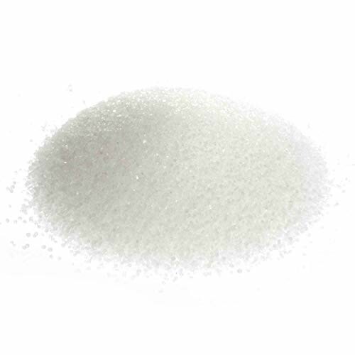 A pile of white granulated sugar on a white background.