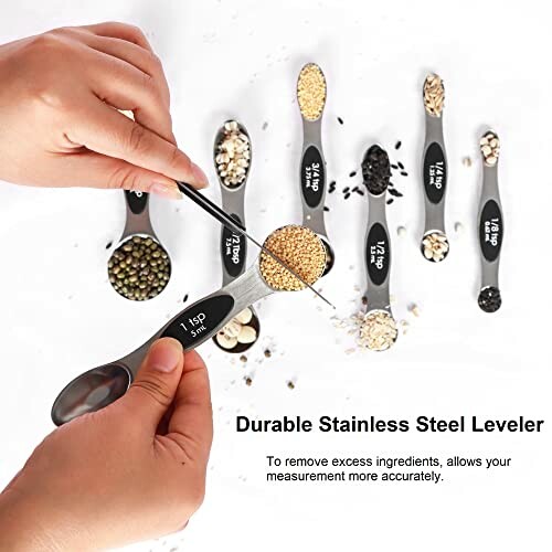 Hands using stainless steel measuring spoons with various grains.